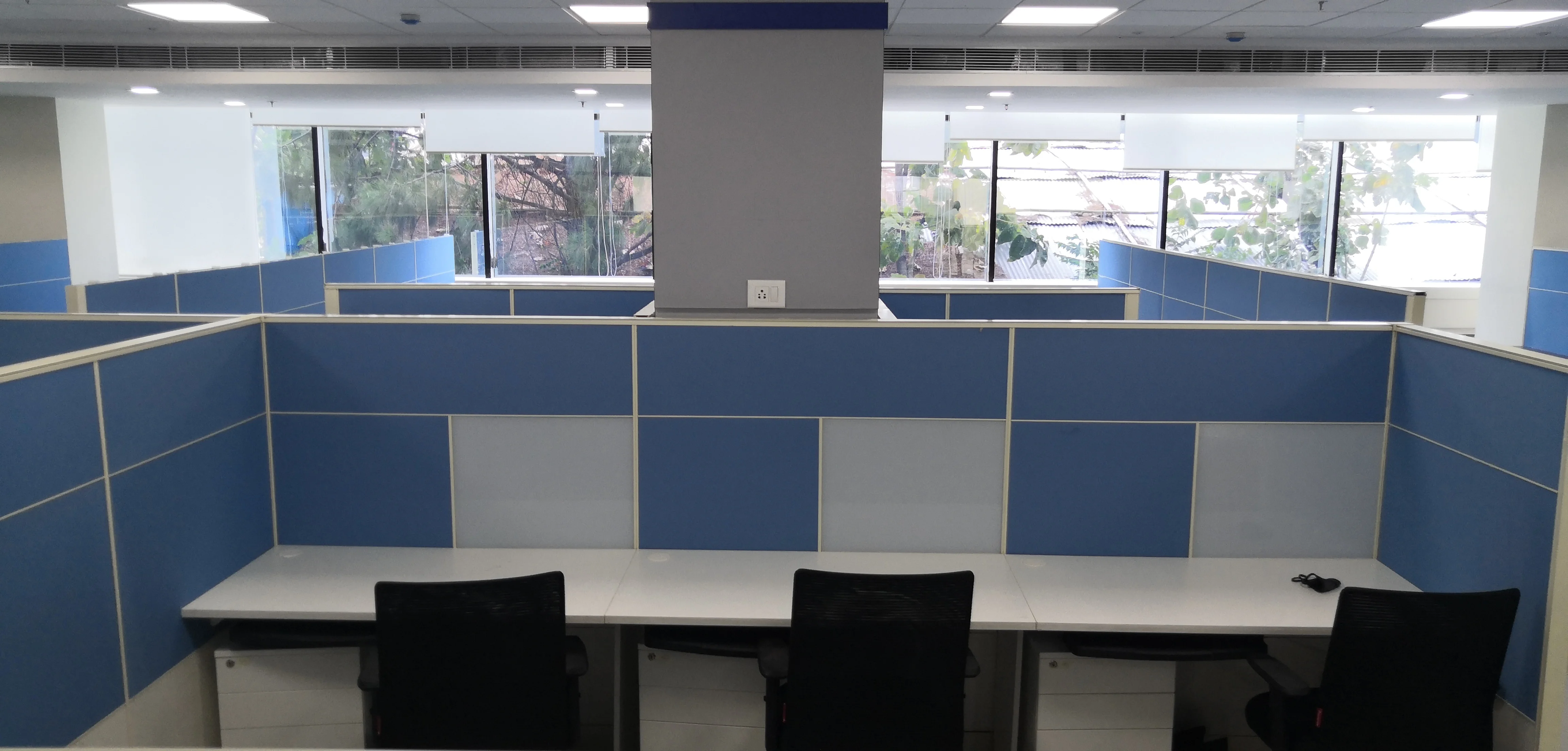 Workstations arranged around blue partition screens