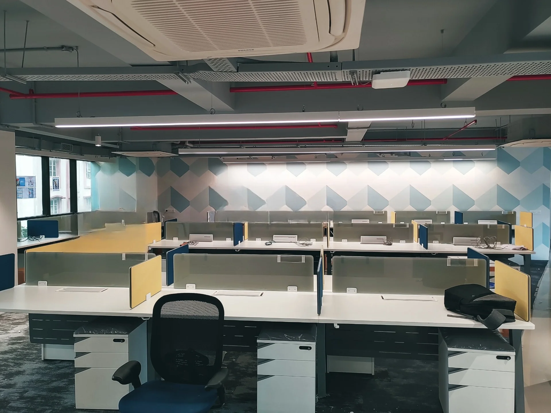 Open office with shared workstations and partition screens